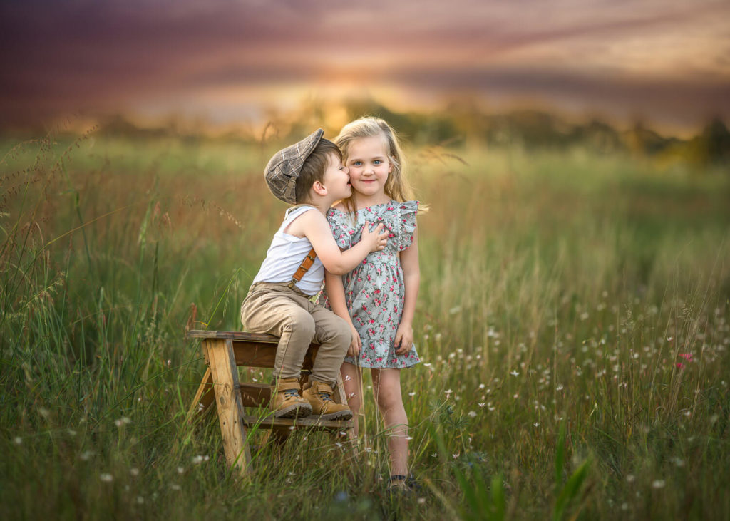 Sibling kissing and hugging each other during outdoor Sibling Photography session in Jane Brook, Perth