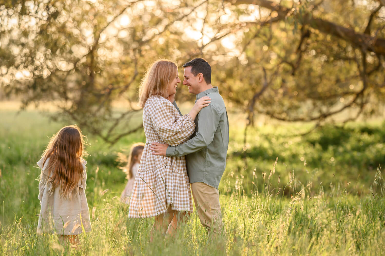 Perth couple hugging during outdoor family session at Lilac Hill in Guildford